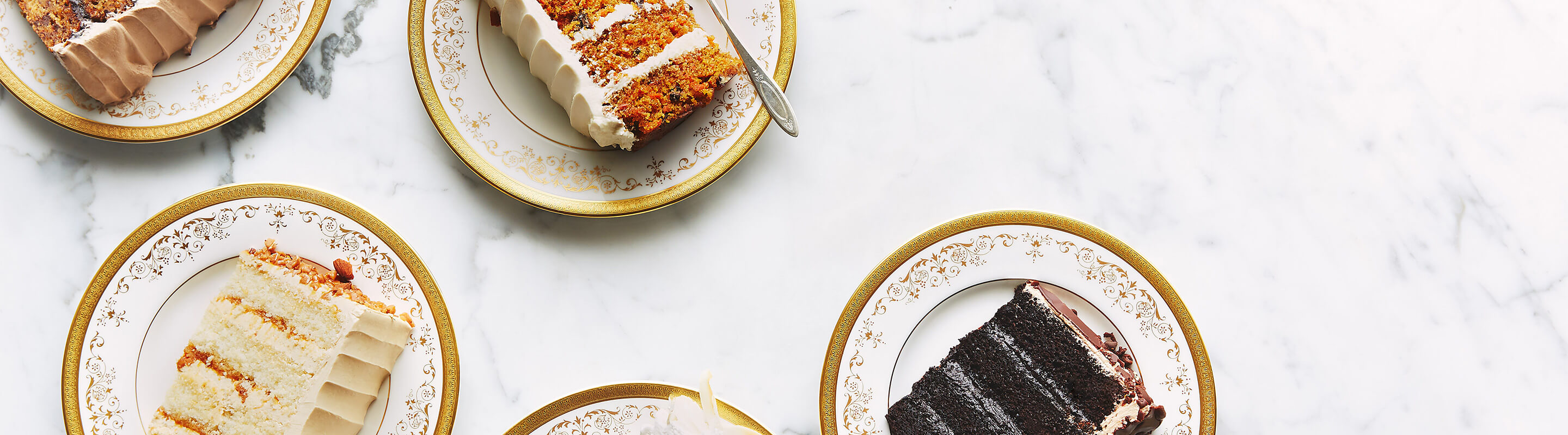 Assorted slices of cakes in various flavours from Bobbette & Belle, including carrot cake, ultimate chocolate and salted caramel