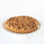 Full-sized apple crumble pie with spiced apples and a golden buttery crumble topping, perfect for family gatherings and dessert lovers