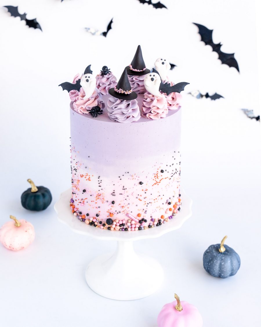 Halloween Cake 1 Halloween cake decorated with pastel purple ombre frosting, fondant ghosts, witch hats, and bats, with festive sprinkles