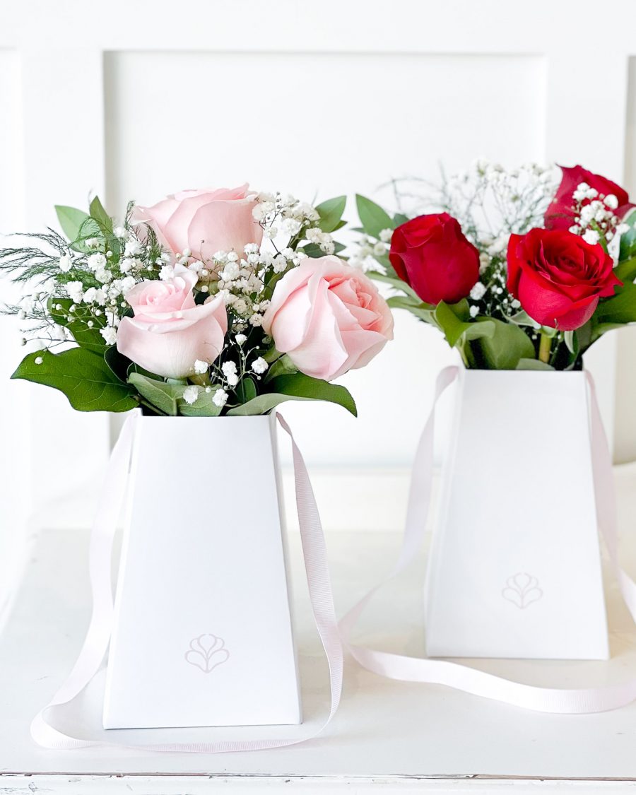 Red and Pink Valentine's Roses A luxury rose bouquet in a sleek white gift bag, featuring soft pink and deep red roses, accented with baby’s breath and fresh greenery.