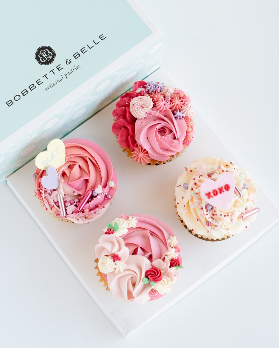 4 piece Valentines Cupcakes Box of four Valentine’s cupcakes decorated with tinted vanilla buttercream and fondant heart toppers.